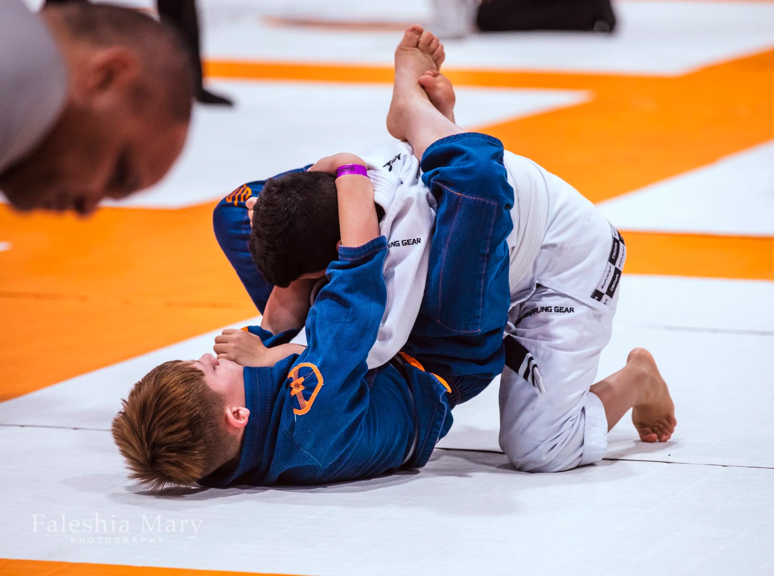 Two young Eagle Mountain BJJ students grappling at a competition